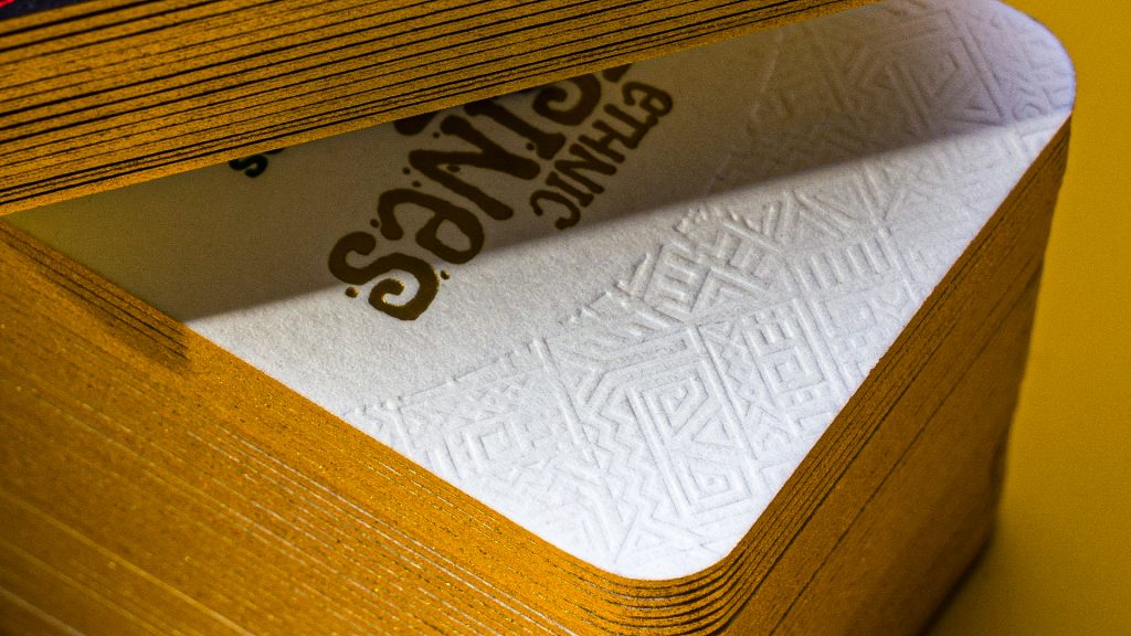 white debossed business cards with gold edges