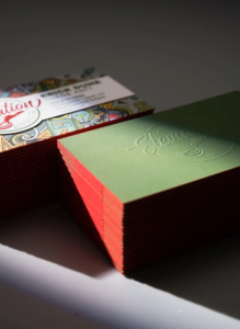 green blind embossed business cards with red painted edges