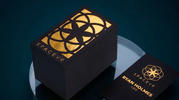 A soft-touch black suede card with a gold-foil geometric pattern.
