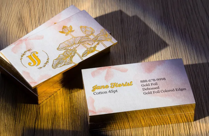 Cotton 45pt card with gold foil edges and a gold foil floral design for a florist